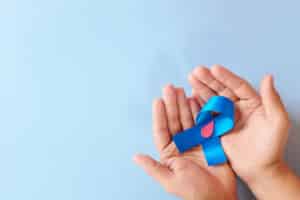 Hands holding a Diabetes blue ribbon